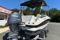 2010 Hurricane SunDeck Sport 200 OB boat with Yamaha outboard motor on trailer.
