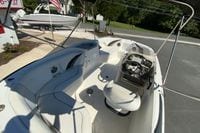 2010 Hurricane SunDeck Sport 200 OB boat interior with seating and steering console.