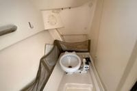 Interior of 2011 Grady-White Freedom 255 boat, featuring a compact marine toilet.