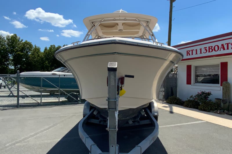 2011 Grady-White Freedom 255 boat on trailer at dealership, sunny day.
