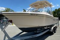 2011 Grady-White Freedom 255 boat on trailer under clear blue sky.