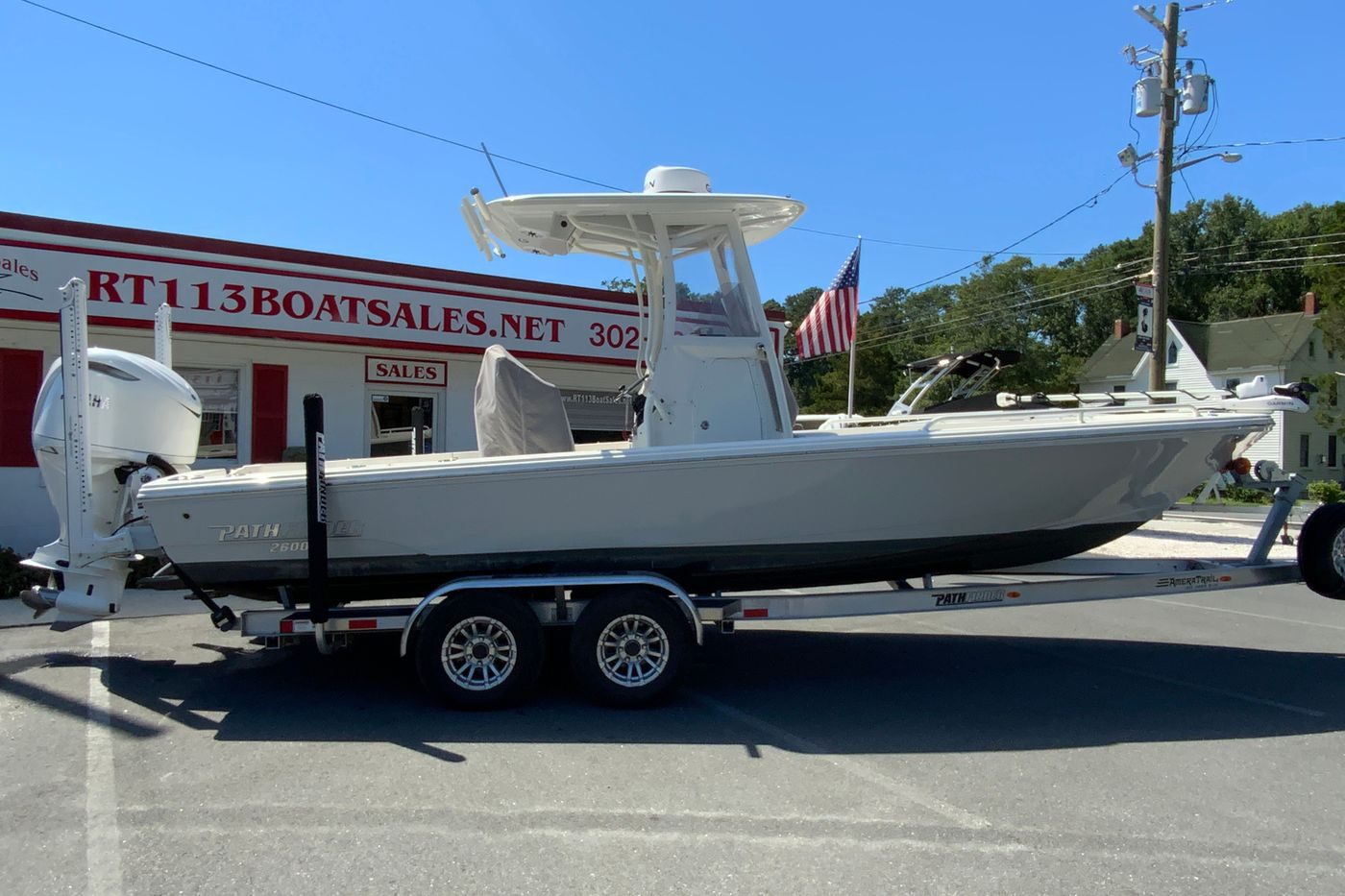 2025 Pathfinder 2600 TRS boat on trailer outside dealership, showcasing sleek design and modern features.