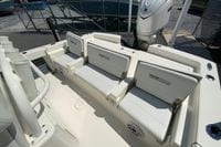 2025 Pathfinder 2600 TRS boat interior with seating and motor, docked outdoors.