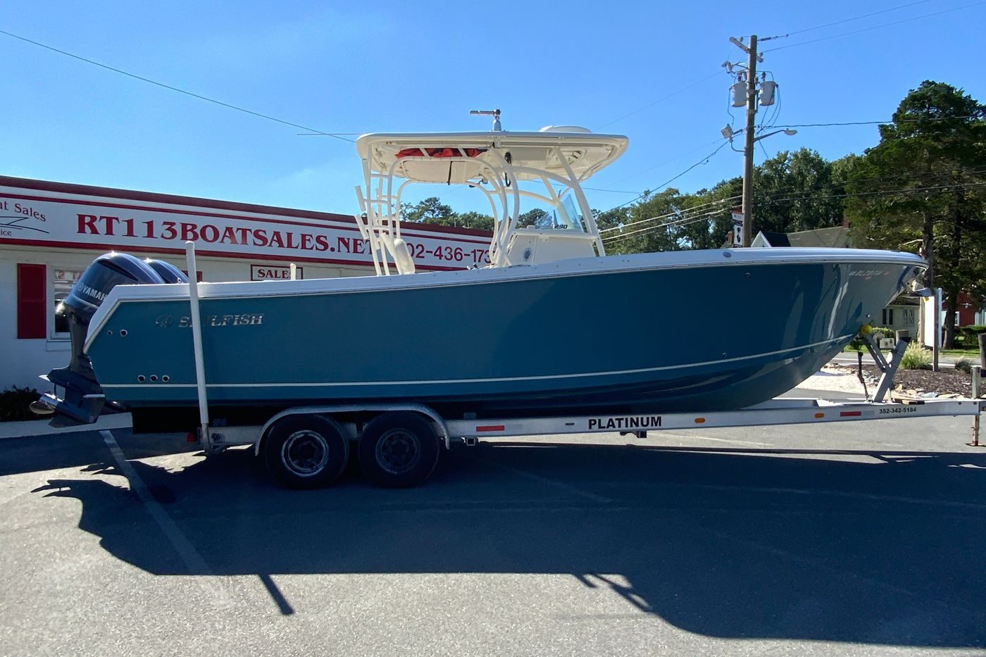 2014 Sailfish 290 CC boat on trailer at RT113 Boat Sales.
