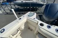 2014 Sailfish 290 CC boat interior with fishing rod holders and engine view.
