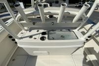 2014 Sailfish 290 CC boat console with rod holders and livewell.