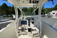 2014 Sailfish 290 CC boat cockpit with steering wheel and control panel.