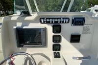 Helm of 2014 Sailfish 290 CC boat with navigation and control instruments.
