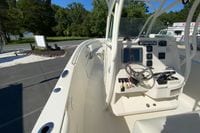 2014 Sailfish 290 CC boat cockpit with steering wheel and control panel.