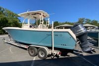 2014 Sailfish 290 CC boat on trailer with Yamaha engine, parked outdoors.