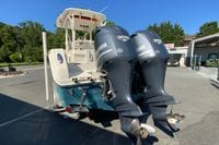2014 Sailfish 290 CC boat with dual Yamaha 300 V6 engines, parked outdoors.