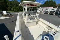 2014 Sailfish 290 CC boat at dealership, showcasing spacious deck and seating area.