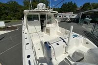2027 Pursuit D 326 Denali boat at dealership, showcasing spacious deck and seating area.