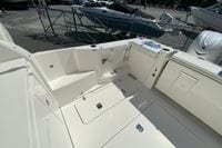 2027 Pursuit D 326 Denali boat deck with seating and storage compartments.