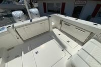 2027 Pursuit D 326 Denali boat interior with storage compartments and twin engines.