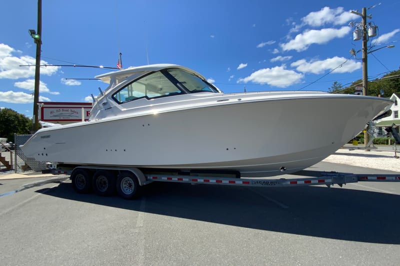 2027 Pursuit D 326 Denali boat on trailer under clear blue sky.