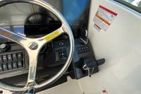 Steering wheel and controls of 2027 Pursuit D 326 Denali boat cockpit.