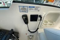 Control panel of 2027 Pursuit D 326 Denali boat with radio and cup holders.