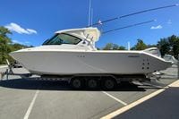 2027 Pursuit D 326 Denali boat on trailer under clear blue sky.