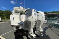 2027 Pursuit D 326 Denali boat with twin Yamaha 350 V6 engines, docked outdoors.