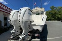 2027 Pursuit D 326 Denali boat with twin Yamaha 350 V6 engines at dealership.