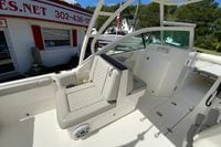 2024 Pursuit DC 246 Dual Console boat interior with seating and helm, displayed outdoors.