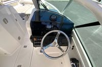 2024 Pursuit DC 246 Dual Console boat helm with steering wheel and control panel.