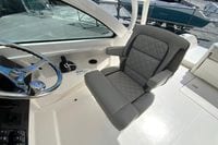 2024 Pursuit DC 246 Dual Console boat interior with luxurious captain's seat and steering wheel.
