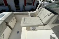 2024 Pursuit DC 246 Dual Console boat interior with cushioned seating and storage compartments.
