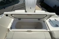 2024 Pursuit DC 246 Dual Console boat with open storage compartment and seating area.