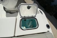 Open storage compartment on 2024 Pursuit DC 246 Dual Console boat deck.