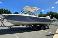 2024 Pursuit DC 246 Dual Console boat on trailer under clear blue sky.