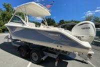2024 Pursuit DC 246 Dual Console boat on trailer with Yamaha engine, outdoors.
