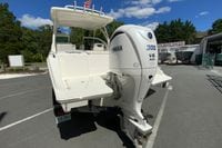 2024 Pursuit DC 246 Dual Console boat with Yamaha 300 V6 engine, parked outdoors.