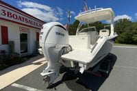 2024 Pursuit DC 246 Dual Console boat with Yamaha V6 engine at dealership.