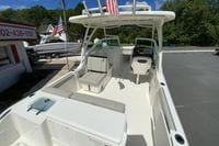 2024 Pursuit DC 246 Dual Console boat with seating and helm, parked outdoors.