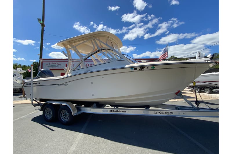 2017 Grady-White Freedom 255 boat on trailer under clear blue sky.