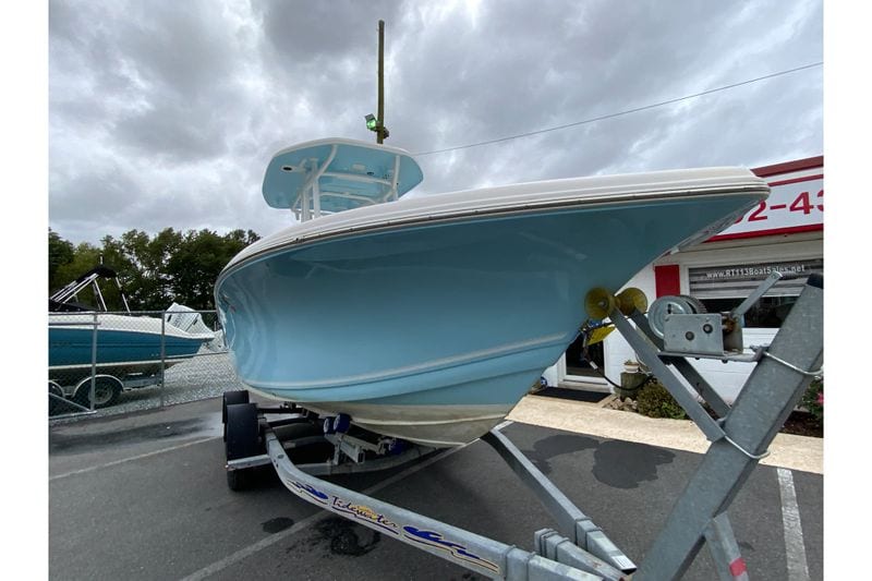 2023 Tidewater 220 CC Adventure boat on trailer under cloudy sky.