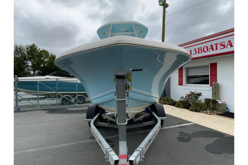 2023 Tidewater 220 CC Adventure boat on trailer, parked outside dealership.