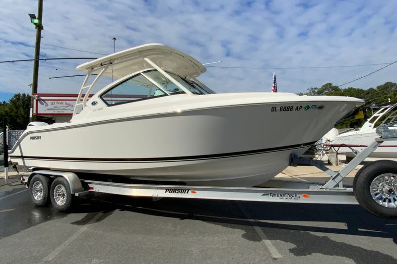 2024 Pursuit DC 266 Dual Console boat on trailer, displayed outdoors.