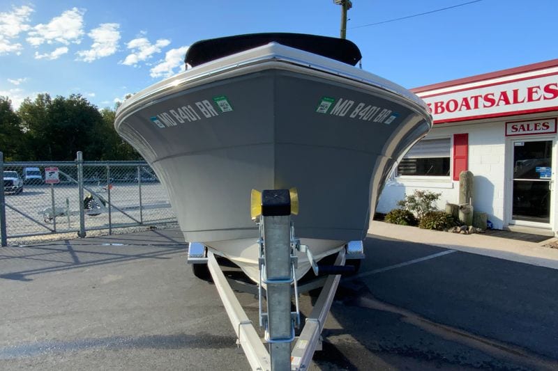 2021 Cobia 220 Dual Console boat on trailer at dealership.