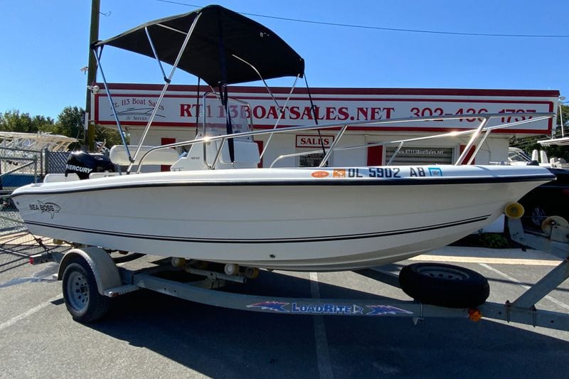 2008 Sea Boss 190 Center Console boat on trailer, parked at a boat sales lot.