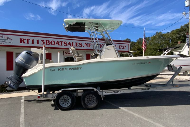 2023 Key West 219 FS boat on trailer at dealership, featuring Yamaha engine.