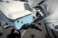 2027 Cobia 250 Dual Console boat with outboard motor, parked on a trailer.