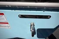 2027 Cobia 250 Dual Console boat with identification plate and safety warnings.