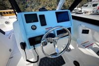 2027 Cobia 250 Dual Console helm with steering wheel and electronic displays.