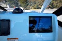 Dashboard of 2027 Cobia 250 Dual Console with Garmin display and compass.