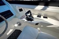 Interior of 2027 Cobia 250 Dual Console boat showing controls and steering wheel.