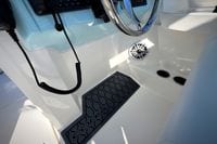 2027 Cobia 250 Dual Console boat interior with steering wheel and speaker.