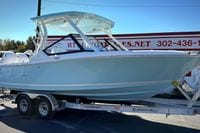 2027 Cobia 250 Dual Console boat on trailer, displayed outdoors.
